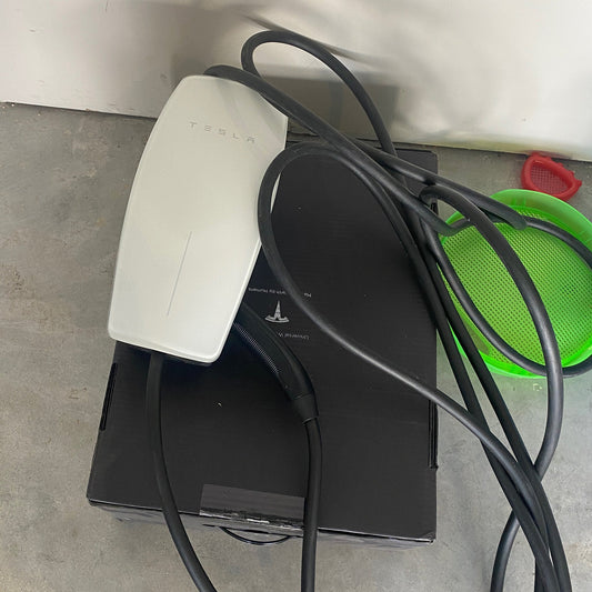 Removed Tesla Wall Connector and charging cable ready to be taken to the homeowner’s new property.