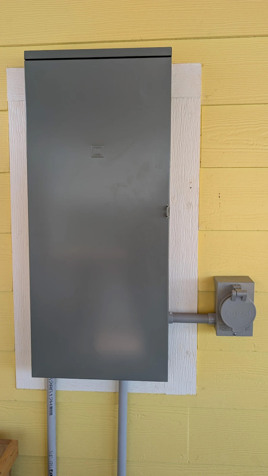 New 200-amp Square D outdoor electrical panel with generator interlock kit and weatherproof generator inlet installed by ProLectric at a Galveston beach house.